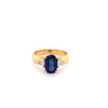 2.32 Carat Oval Cut Blue Sapphire with Trillion Cut Diamond Side stones in 18k Yellow Gold Ring